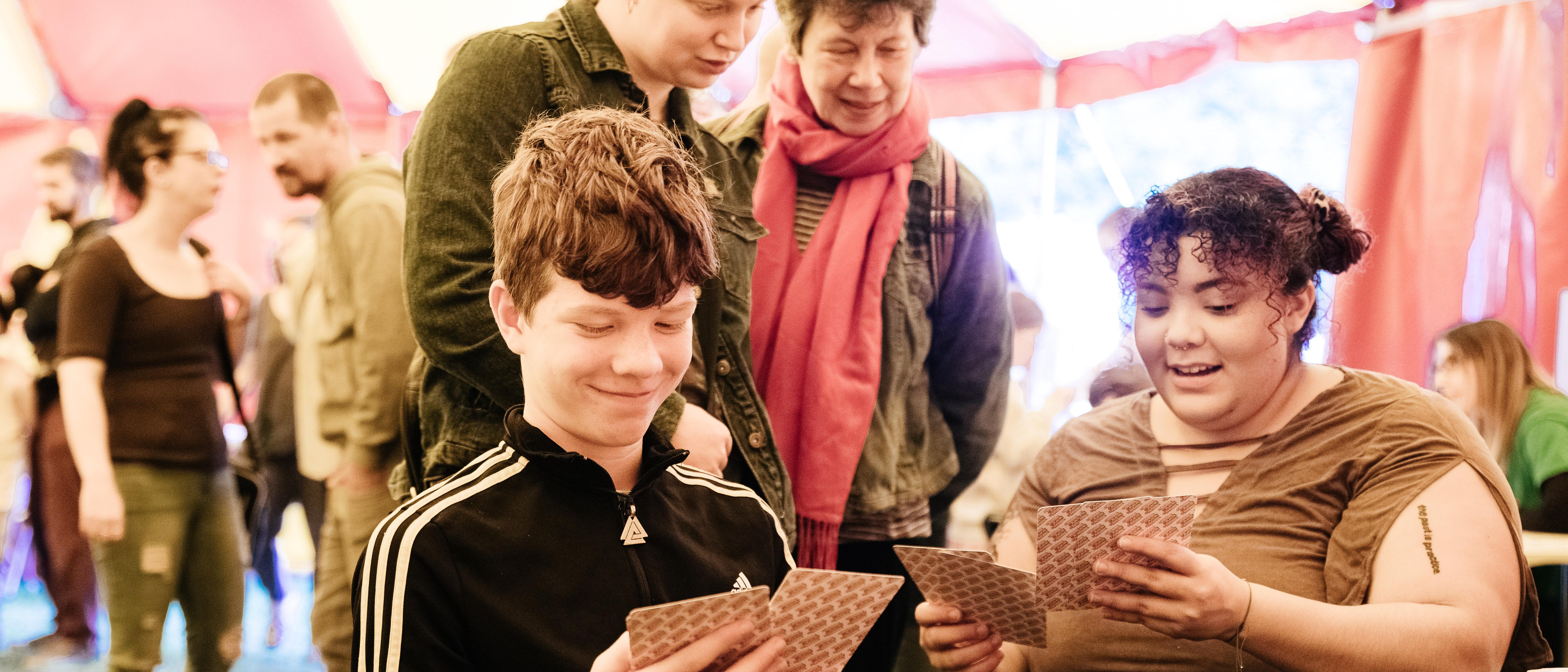 4 people working with illustrated story cards in the big top at tapton lock festival