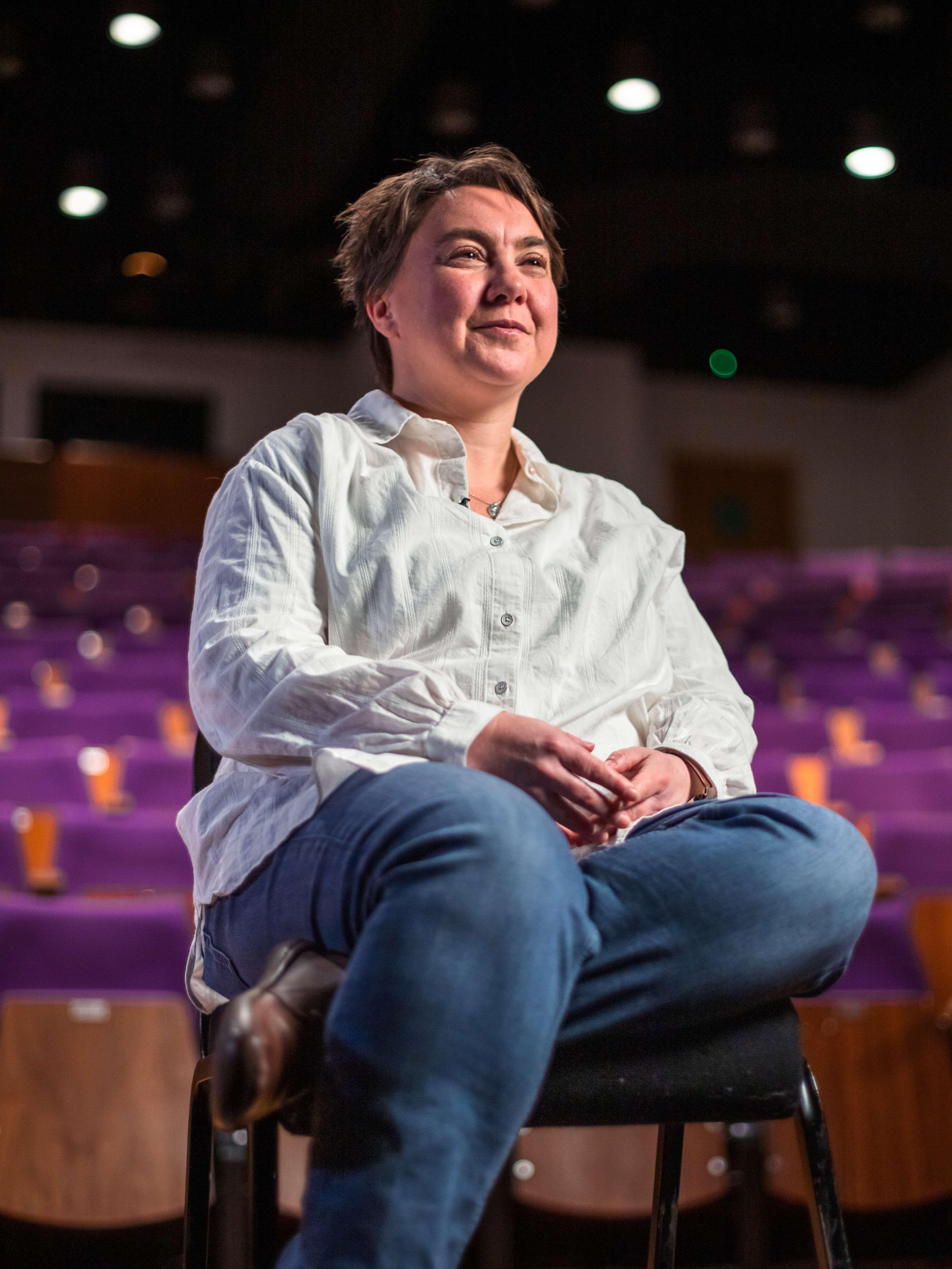 Woman seated in chair looking out