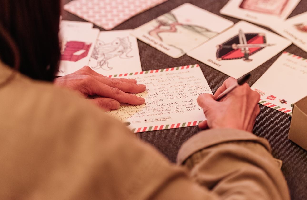 Close up of a story card on a table of activities in the big top at tapton lock festival