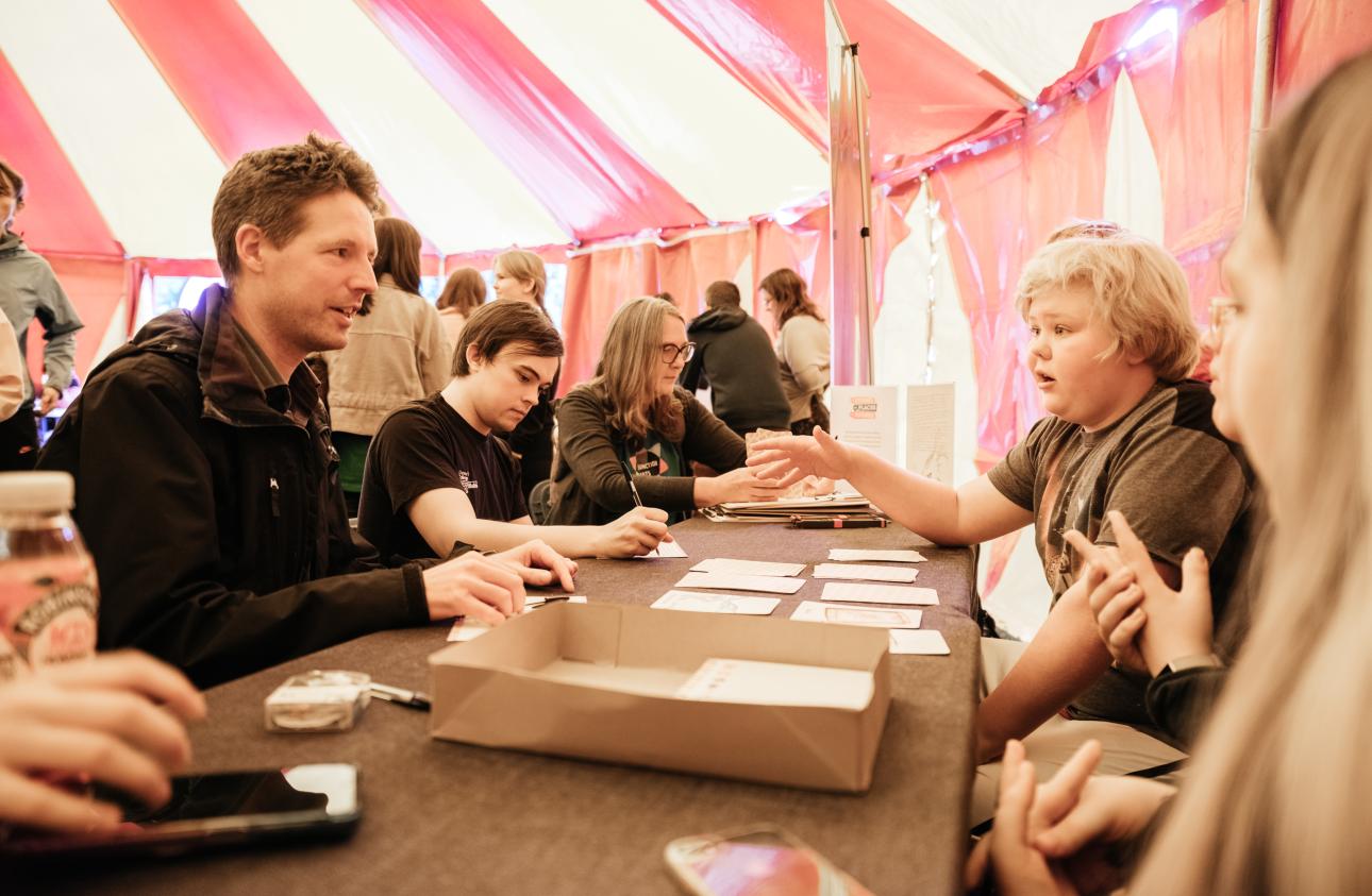 a table of activities with the story cards in the big top at tapton lock festival