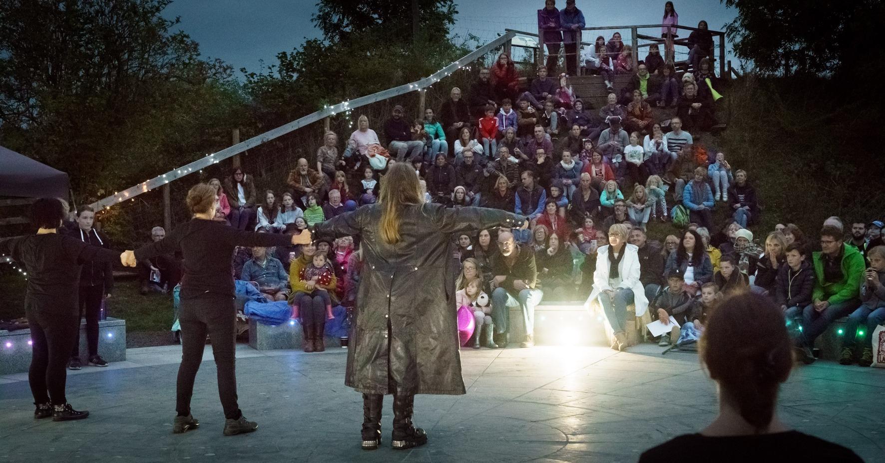 A storyteller performing in front of an audience.