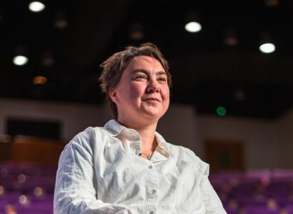 Woman in white shirt, looking out